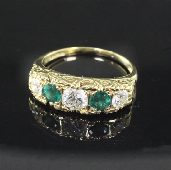 A modern Victorian style 18ct gold, emerald and diamond five stone half hoop ring, size N.